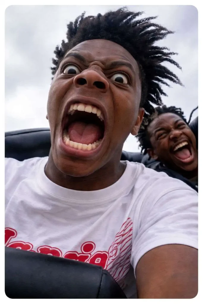 Action selfie of two people screaming with exaggerated expressions during a fast ride outdoors