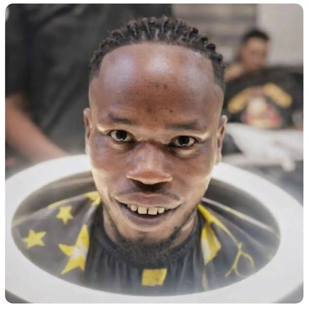 Person with tight braided cornrows styled toward the back, highlighting a prominent forehead and a clean, symmetrical braid pattern