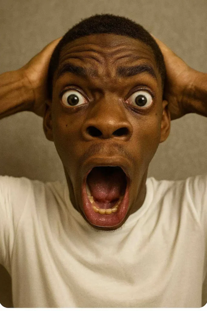 Shocked reaction face holding head with mouth open and eyes wide